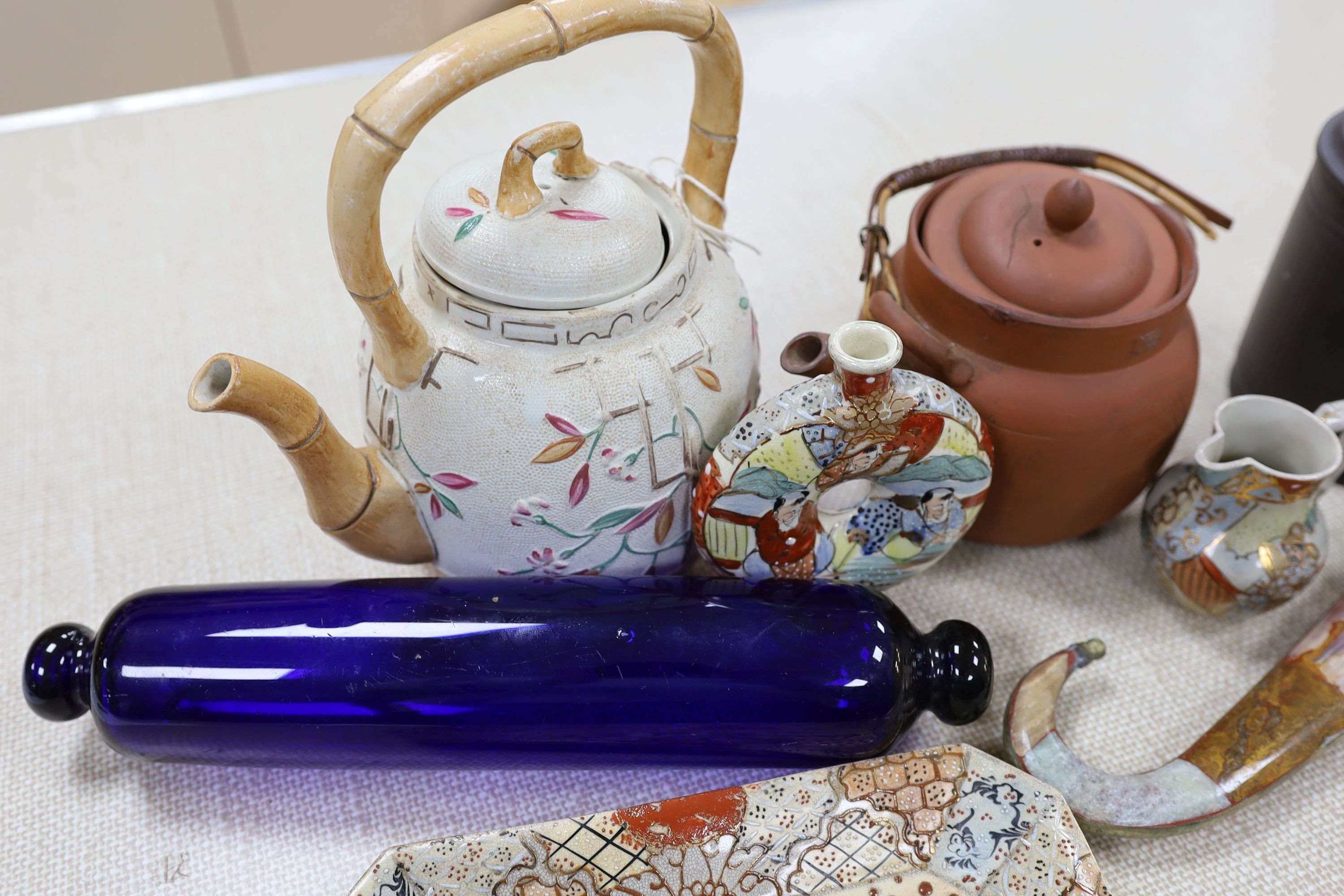 A group of Japanese Satsuma pottery, a Japanese red stoneware teapot, a Chinese Yixing jar and cover, a Middle Eastern dagger and a blue glass rolling pin